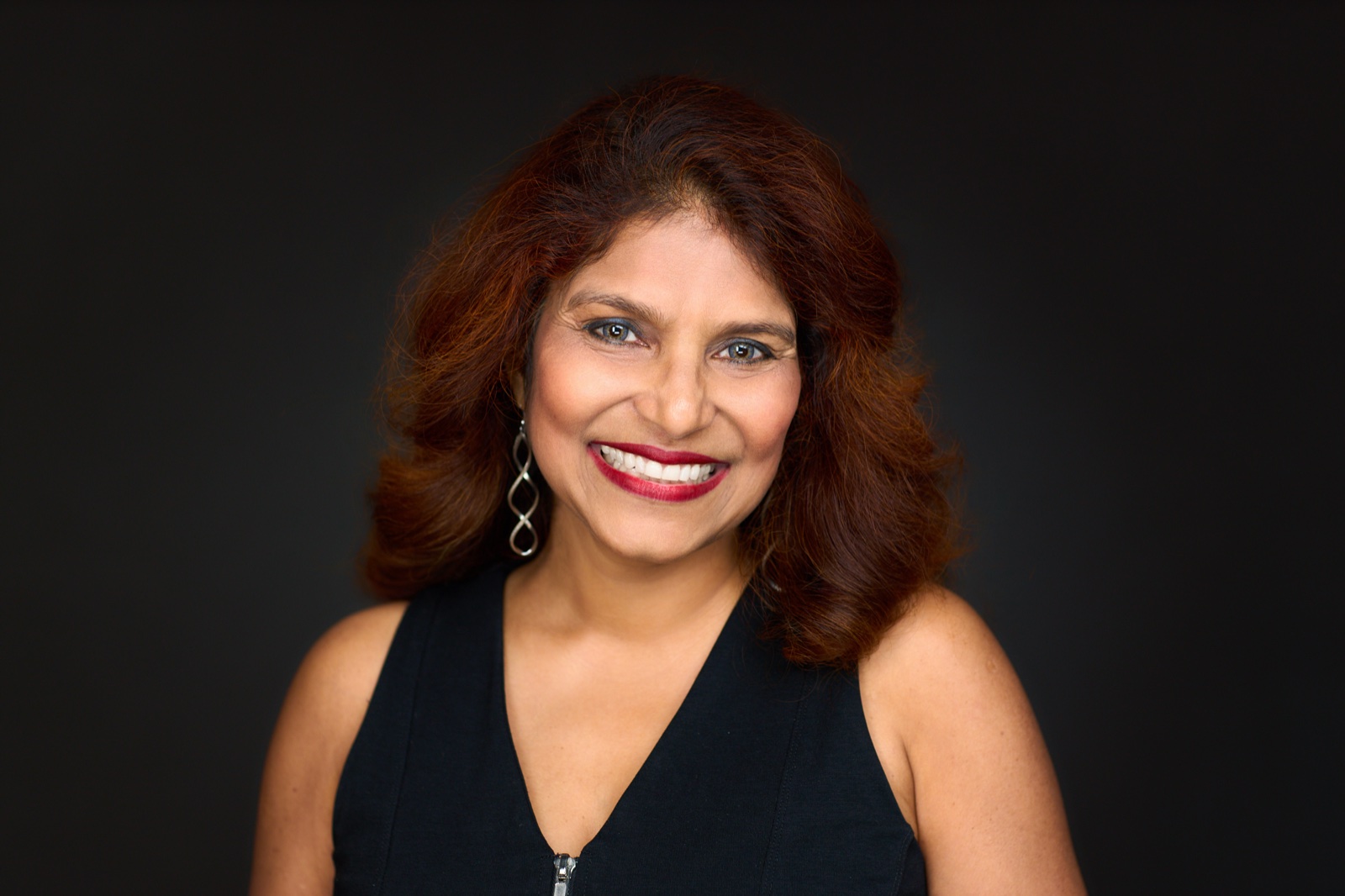 Corporate headshot example on a dark studio background in Sydney