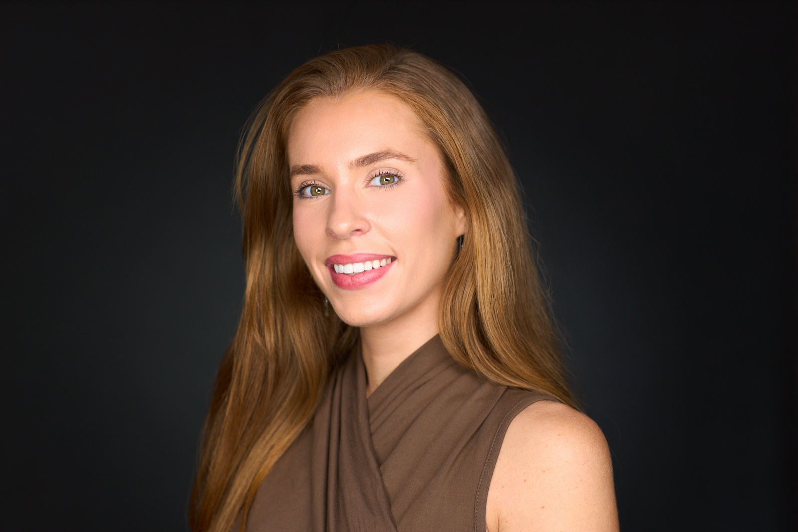 Sydney LinkedIn profile photo with polished wardrobe on a dark studio background